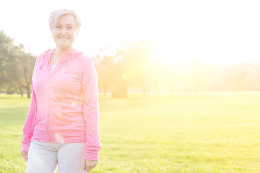 A woman enjoying gentle outdoor movement at sunrise, representing simple non-exercise movement for wellbeing